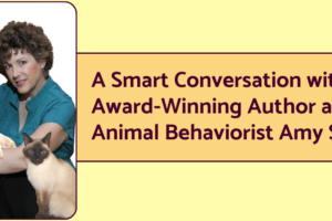 Author and animal behavior consultant Amy Shojai with two of her animal companions, a dog and a cat. The banner next to the photo reads Award Winning Authorpreneur and Animal Behavior Consultant Amy Shojai Talks Writing Books